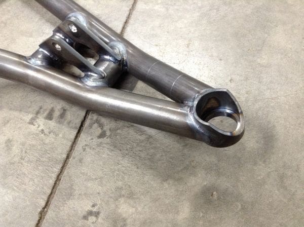 A close up of the bottom end of a bicycle frame.