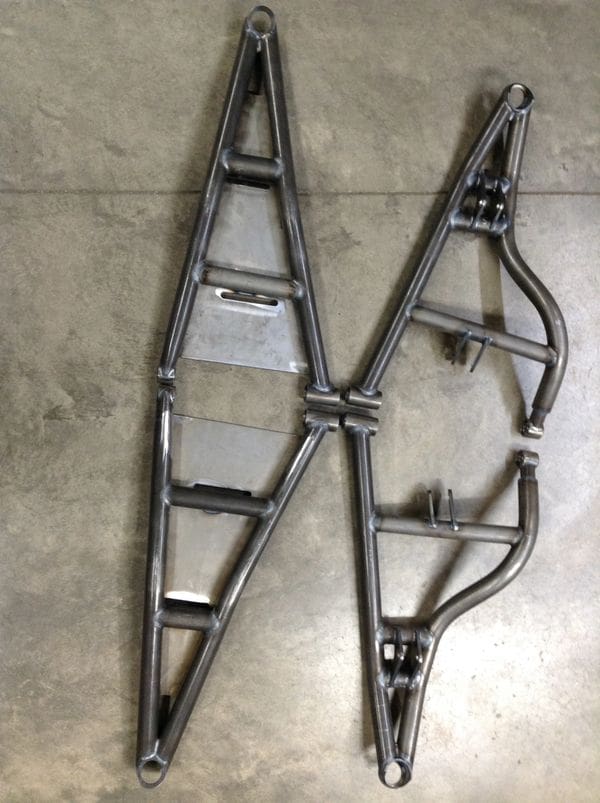 A pair of motorcycle frames sitting on the floor.