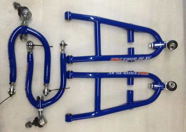 A pair of blue motorcycle suspension arms and two other parts.