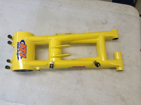 A yellow frame with a black handle on it