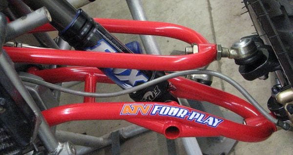 A red bicycle frame with the words " four play ".