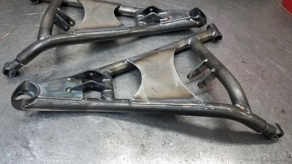 A pair of motorcycle frames sitting on top of the floor.