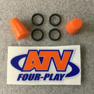 A pair of orange ear plugs and an atv four play sticker.