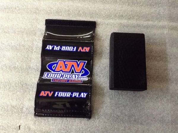A black box of atv fluid play and an empty package.