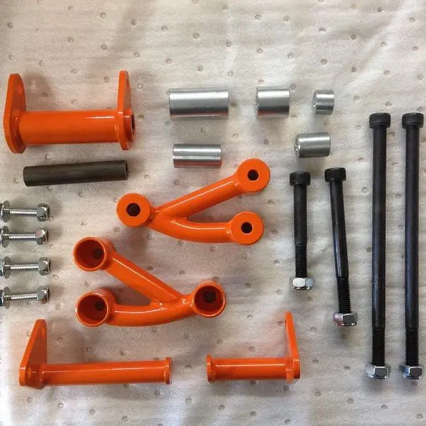 A group of orange and black parts on top of a white cloth.