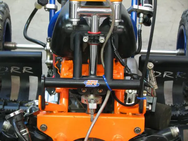 A close up of an orange machine with many parts