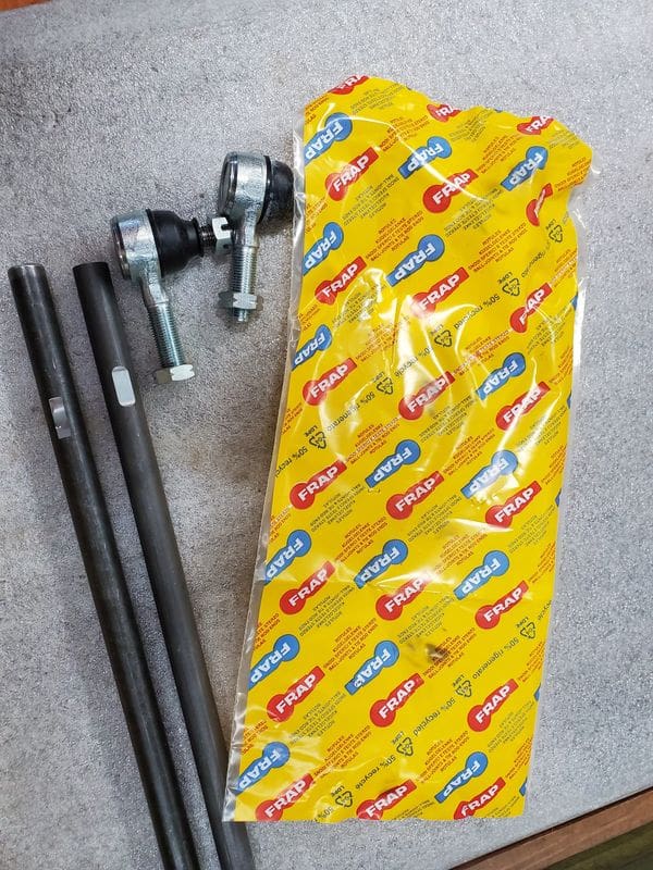 A yellow bag with some black rods and a ball bearing
