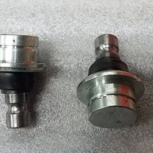 Two different types of ball joints on a table.