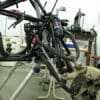 A bicycle frame sitting in the middle of a workshop.