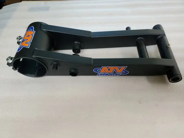 A black metal arm with an orange and blue logo.