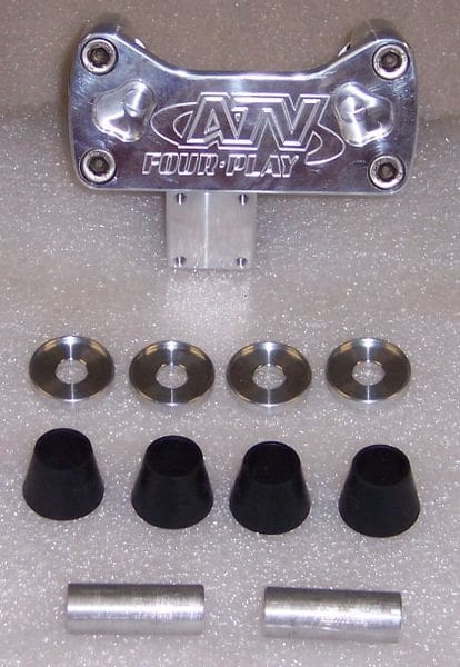 A set of four black knobs and one metal holder.