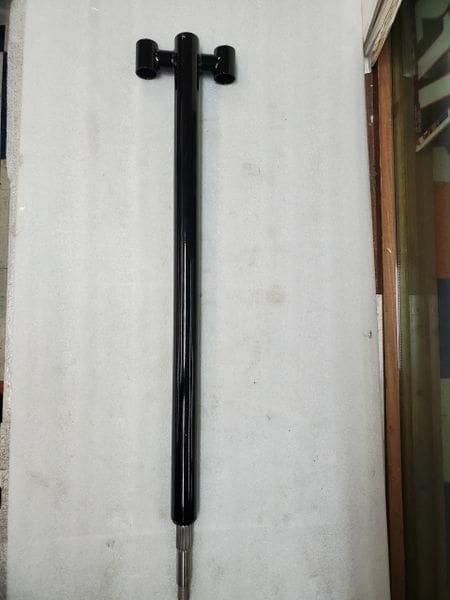 A black pole with a long handle on top of it.