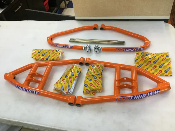 A table with some orange plastic pipes and nuts