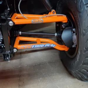 A close up of the front suspension on an atv.